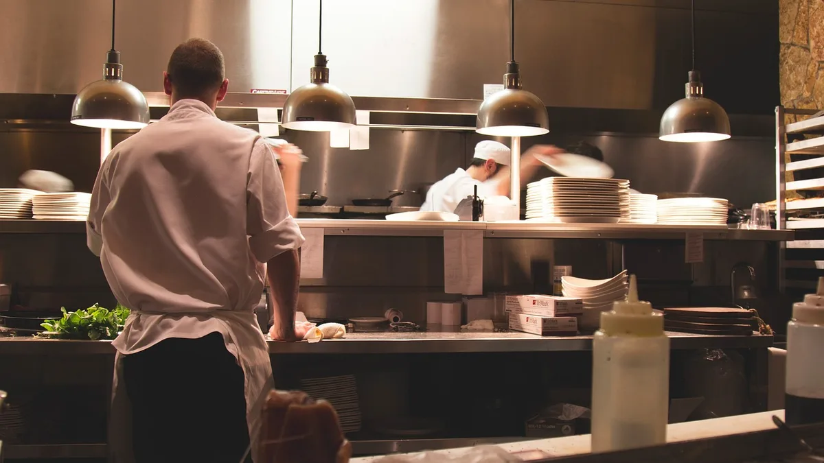 Cooks working the line in a busy restaurant kitchen during service