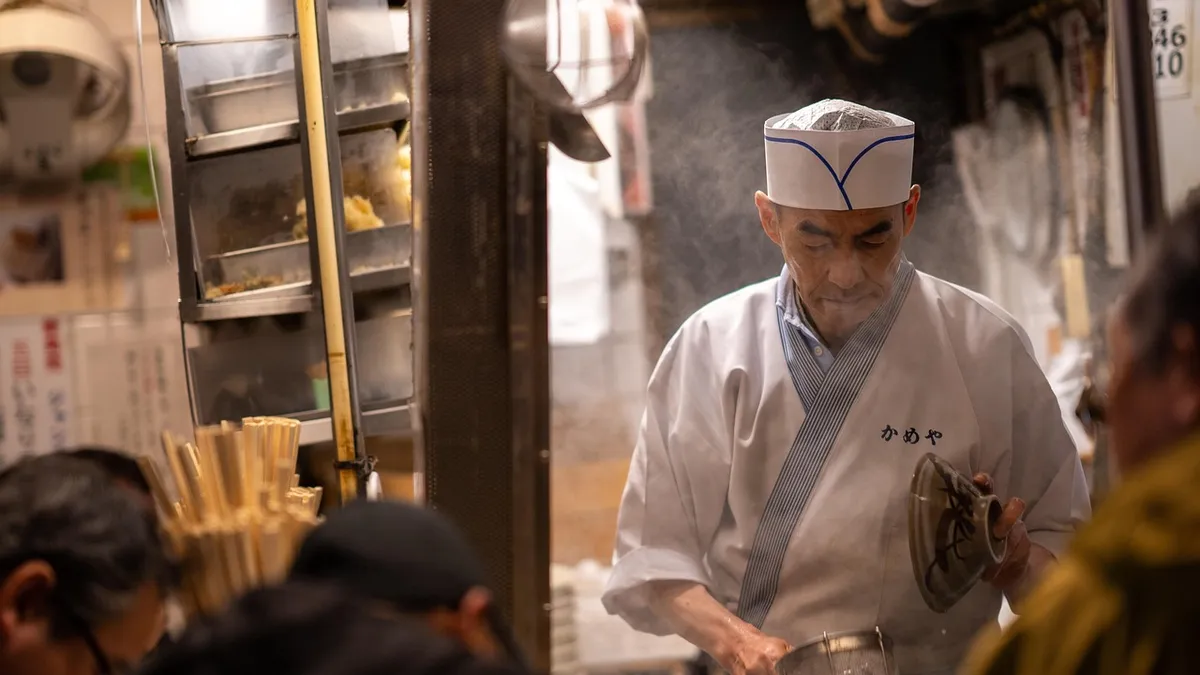 Chefs cooking and preparing dishes on a busy restaurant kitchen line